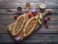 Arabic pizza Lahmacun on dark wooden background.