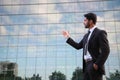 Businessman or worker standing in suit near office building Royalty Free Stock Photo