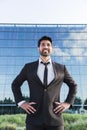 Smiling businessman or worker standing in suit near office building Royalty Free Stock Photo