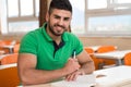 Arabic Student With Books Sitting In Classroom Royalty Free Stock Photo