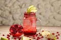 Arabic Style fresh pomegranate mojito with Pear fruit juices served in jar isolated on background top view drink