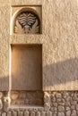 Arabic style window portal in stone wall with ornaments, traditional arabic architecture.