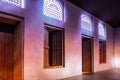 Arabic style window portals and carved wooden doors with arabesque ornaments, Dubai, UAE.