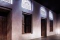 Arabic style window portals and carved wooden doors with arabesque ornaments, Dubai, UAE.