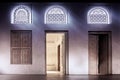 Arabic style window portals and carved wooden doors with arabesque ornaments, traditional Arabic architecture, Dubai, UAE.