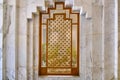 Arabic style wooden window and a white marble wall. Pattern shutters without glass. Interior design element in hotel Tunis, middle Royalty Free Stock Photo