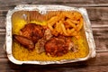 Arabic Syrian cuisine of grilled barbecued chicken with yellow Basmati rice and french fries, fried potatoes fingers served in a Royalty Free Stock Photo