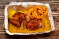 Arabic Syrian cuisine of grilled barbecued chicken with yellow Basmati rice and french fries, fried potatoes fingers served in a Royalty Free Stock Photo