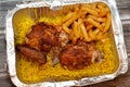 Arabic Syrian cuisine of grilled barbecued chicken with yellow Basmati rice and french fries, fried potatoes fingers served in a Royalty Free Stock Photo