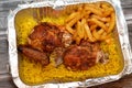 Arabic Syrian cuisine of grilled barbecued chicken with yellow Basmati rice and french fries, fried potatoes fingers served in a Royalty Free Stock Photo