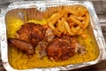 Arabic Syrian cuisine of grilled barbecued chicken with yellow Basmati rice and french fries, fried potatoes fingers served in a Royalty Free Stock Photo