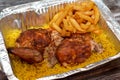 Arabic Syrian cuisine of grilled barbecued chicken with yellow Basmati rice and french fries, fried potatoes fingers served in a Royalty Free Stock Photo