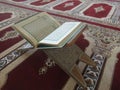 Quran on elegant Persian rugs - the Arabic text with English translation. Royalty Free Stock Photo