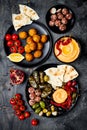 Arabic traditional cuisine. Middle Eastern meze platter with pita, olives, hummus, stuffed dolma, labneh cheese balls, falafel. Royalty Free Stock Photo