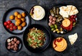 Arabic traditional cuisine. Middle Eastern meze platter with pita, olives, hummus, stuffed dolma, labneh cheese balls, falafel.