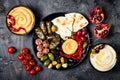 Arabic traditional cuisine. Middle Eastern meze platter with pita, olives, hummus, stuffed dolma, labneh cheese balls in spices. Royalty Free Stock Photo