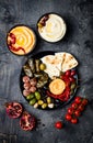 Arabic traditional cuisine. Middle Eastern meze platter with pita, olives, hummus, stuffed dolma, labneh cheese balls in spices.