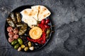 Arabic traditional cuisine. Middle Eastern meze platter with pita, olives, hummus, stuffed dolma, labneh cheese balls in spices. Royalty Free Stock Photo