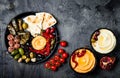 Arabic traditional cuisine. Middle Eastern meze platter with pita, olives, hummus, stuffed dolma, labneh cheese balls in spices. Royalty Free Stock Photo