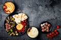 Arabic traditional cuisine. Middle Eastern meze platter with pita, olives, hummus, stuffed dolma, labneh cheese balls in spices. Royalty Free Stock Photo