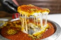 Arabic traditional dessert - kunafa - konafa in a tray with pistachio - creative delicious middle eastern dish - Arabic Cuisine