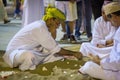 Arabic traditional game of Hawalais with shells on sand is being played by a group of old men