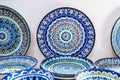 Arabic Uzbek handmade ceramic plates with hand-painted with a traditional East Asian colorful pattern in a pottery Royalty Free Stock Photo