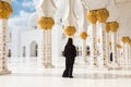 Arabic woman in black burka in Sheikh Zayed Grand Mosque, Abu Dhabi, UAE. Royalty Free Stock Photo