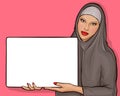 Arabic woman in hijab with billboard