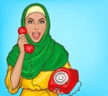 Arabic woman in hijab talking on vintage phone