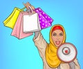 Arabic woman with loud speaker and shopping bags