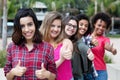 Arabic woman showing thumb with group of girlfriends