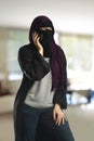 Arabic woman wearing a burqa on the cell phone Royalty Free Stock Photo