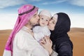 Arabic young couple kiss their son