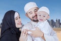 Arabic young couple smiling at baby