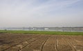 Arable ploughed farm fields on edge of large river