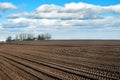 arable field of agricultural field while preparing land for sowing, with cloudly blue sky at spring Royalty Free Stock Photo