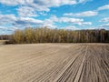 Arable field near the forest on a sunny day, aerial view. Agricultural field Royalty Free Stock Photo