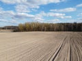 Arable field near the forest on a sunny day, aerial view. Agricultural field Royalty Free Stock Photo