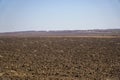 Arable land in spring against the blue sky Royalty Free Stock Photo