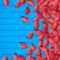 Arachis or peanuts background with red scattered nuts and beans