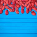 Arachis or peanuts background with red scattered nuts and beans