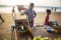 Indian woman preparing roasted sweet yellow corn at the beach