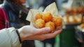 Arancini balls in craft paper bag in the woman& x27;s arms Royalty Free Stock Photo