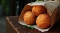 Arancini balls in craft paper bag on the wooden table Royalty Free Stock Photo