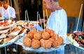 Arancini for hungry customers of street market, tasty stuffed rice balls, traditional sicilian snack on Royalty Free Stock Photo