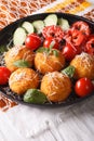 Arancini rice balls with parmesan and fresh vegetables. vertical
