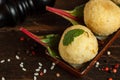 Arancini, a traditional Italian appetizer, fried rice balls with mozzarella. Close-up on a dark wooden background