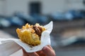 An arancino, the typical sicilian street food