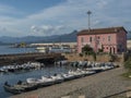 Arbatax, Sardinia, Italy, September 9, 2020: View of Arbatax harbour, port with ships, fishing boats and pink house of